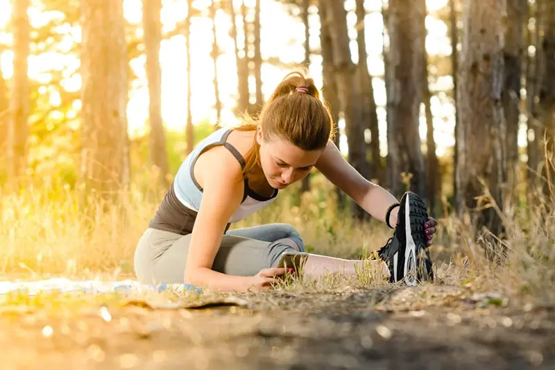 Chiropractic Huntsville AL Woman Stretching Trail